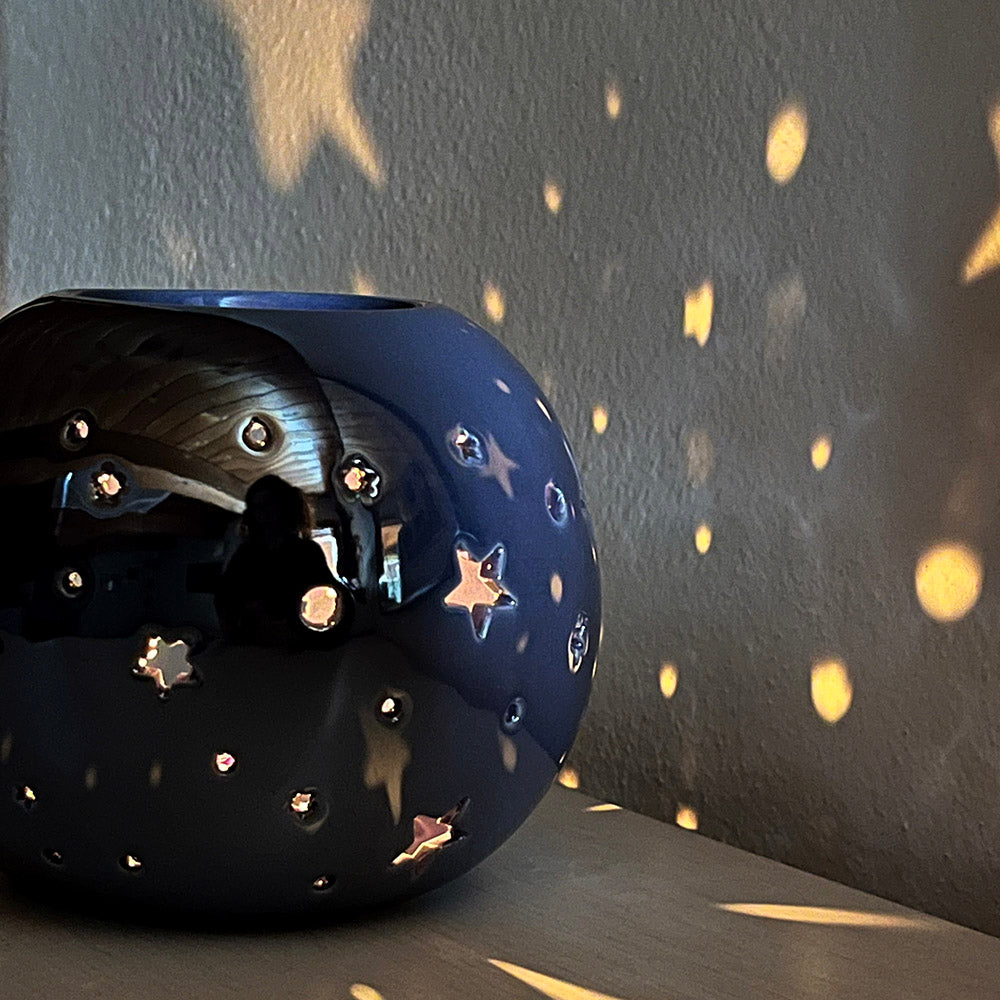 Decorative oil burning sphere, iridescent purple, star projecting lantern, witchy vibes
